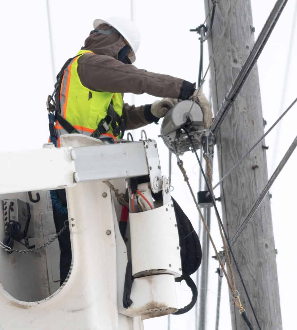 ASTAC Technician Lashing a Fiber Cable to Aerial Strand_Utqiagivik, AK