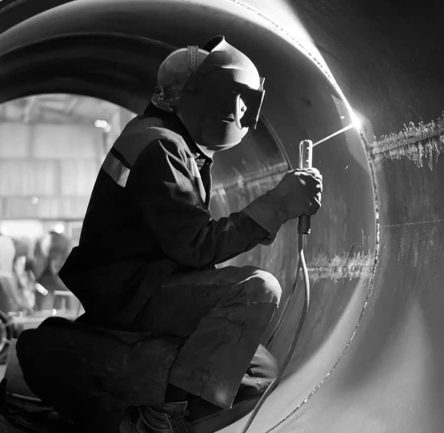 a welder working in a large cynlinder
