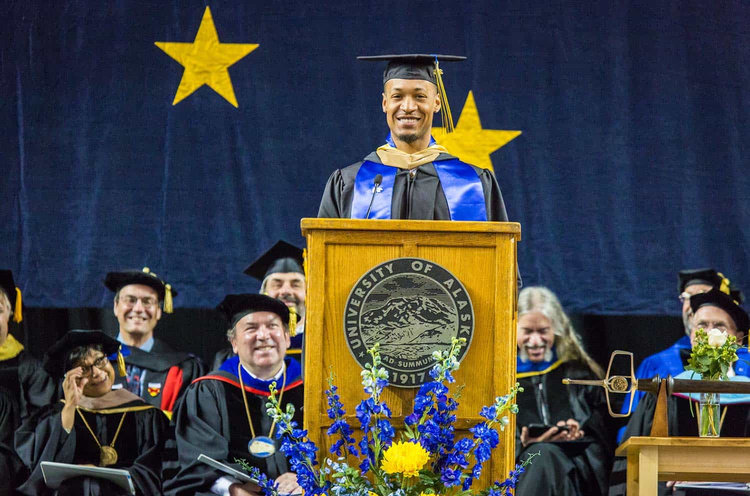 a black student giving a speech at graduation