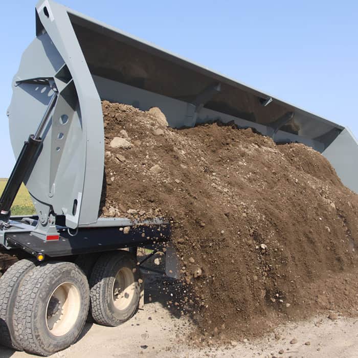 dumping dirt out of a side loader