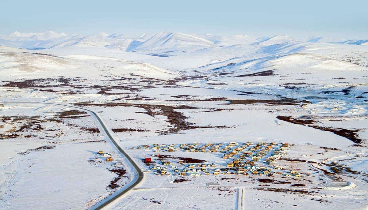 an aerial view of a rural snowy town in Alaska