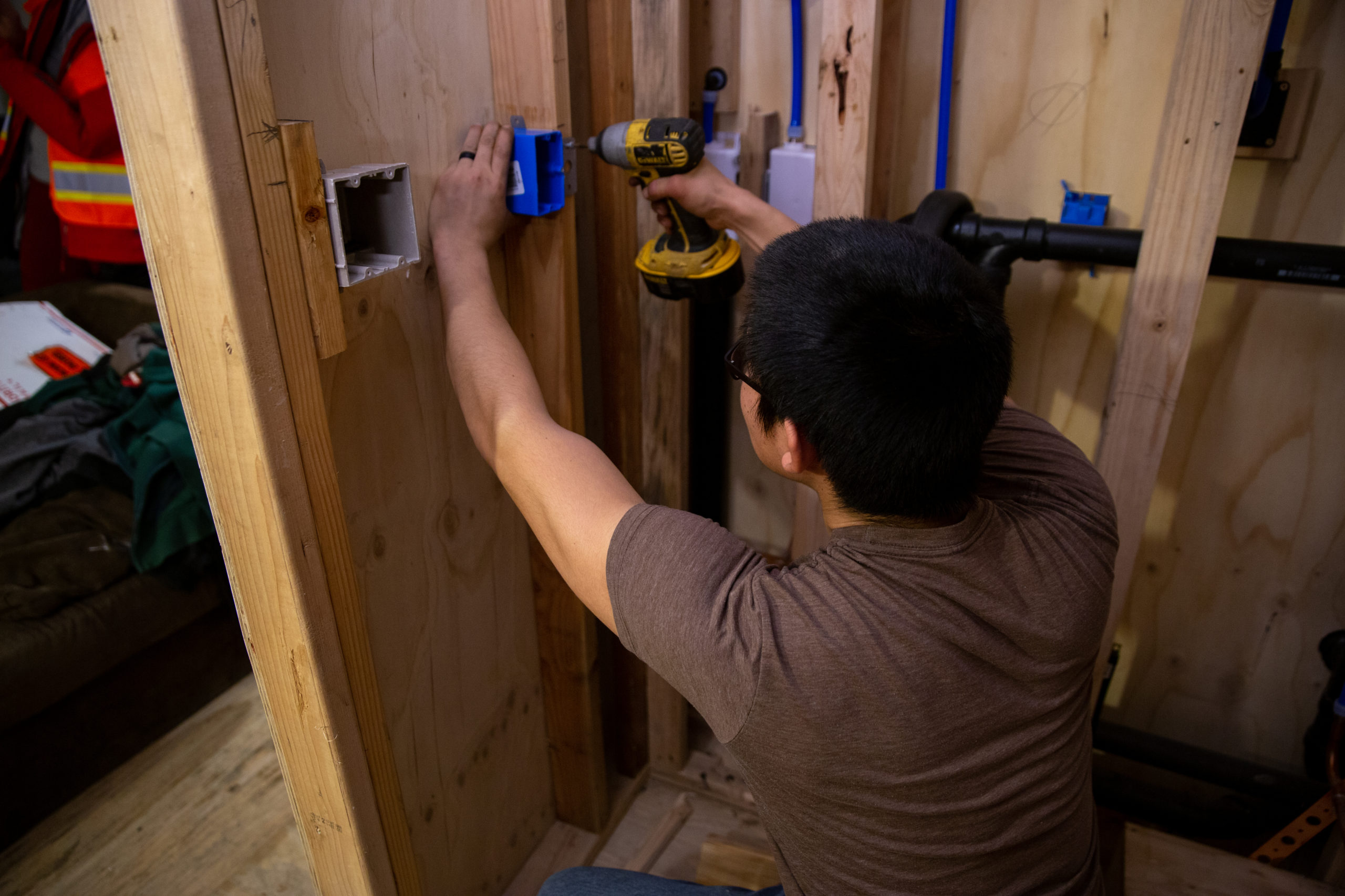 An ANTHC worker installs electrical wiring and indoor plumbing in a house in Eek in 2019. An ANTHC worker installs electrical wiring and indoor plumbing in a house in Eek in 2019.