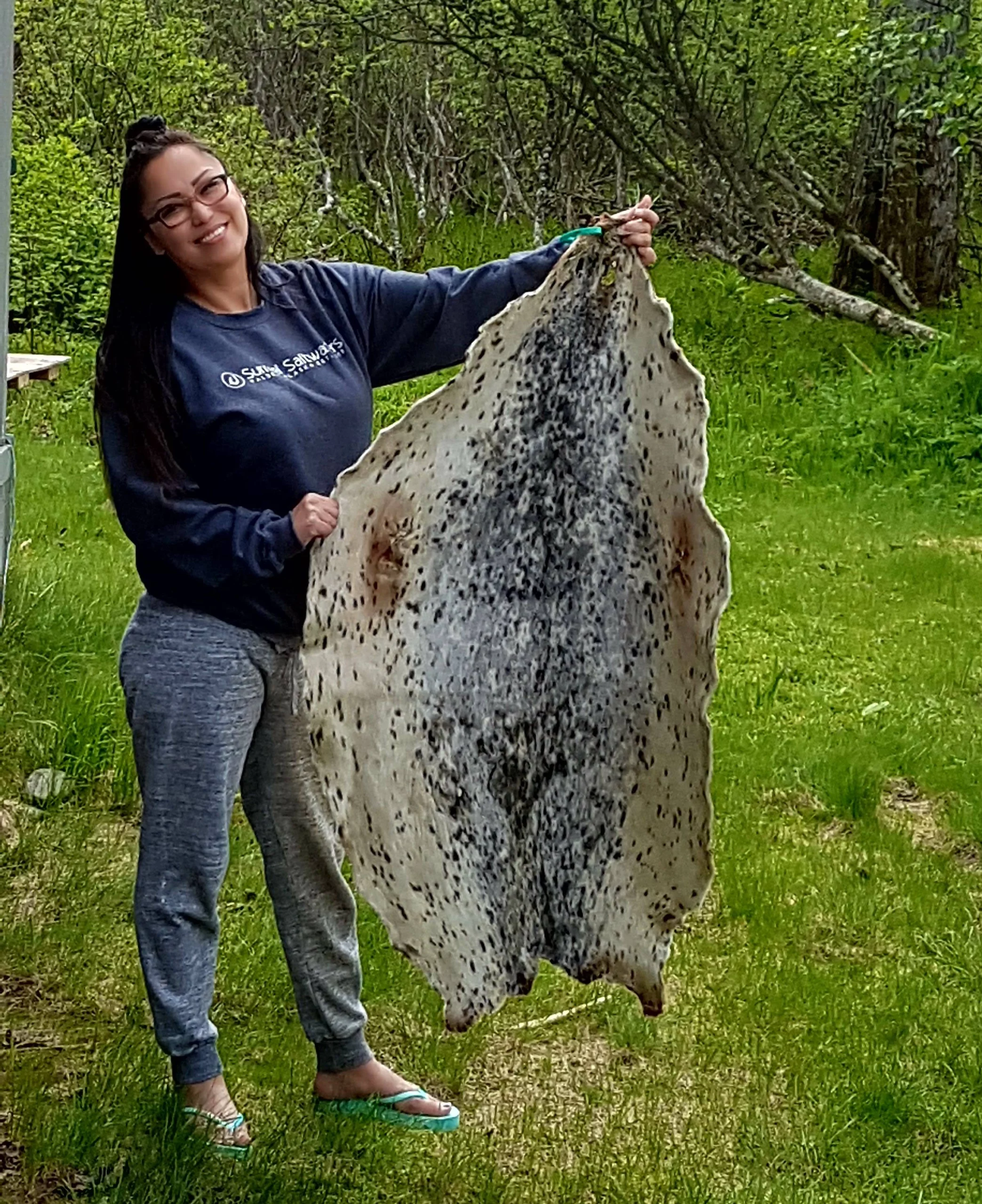 girl holding up animal hide