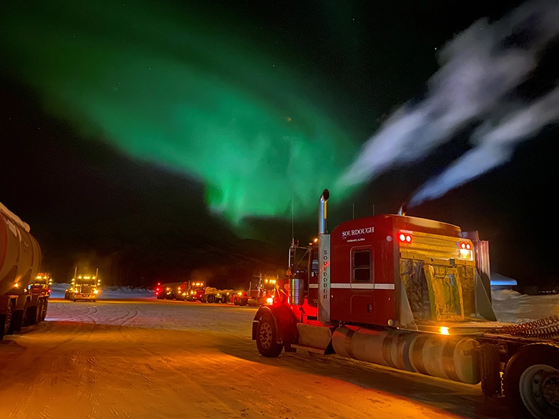 Truck at night under northern lights