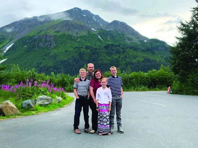 family picture with alaska mountains in the background