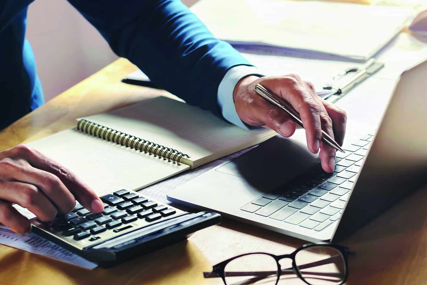 businessman working on desk with using calculator and computer i